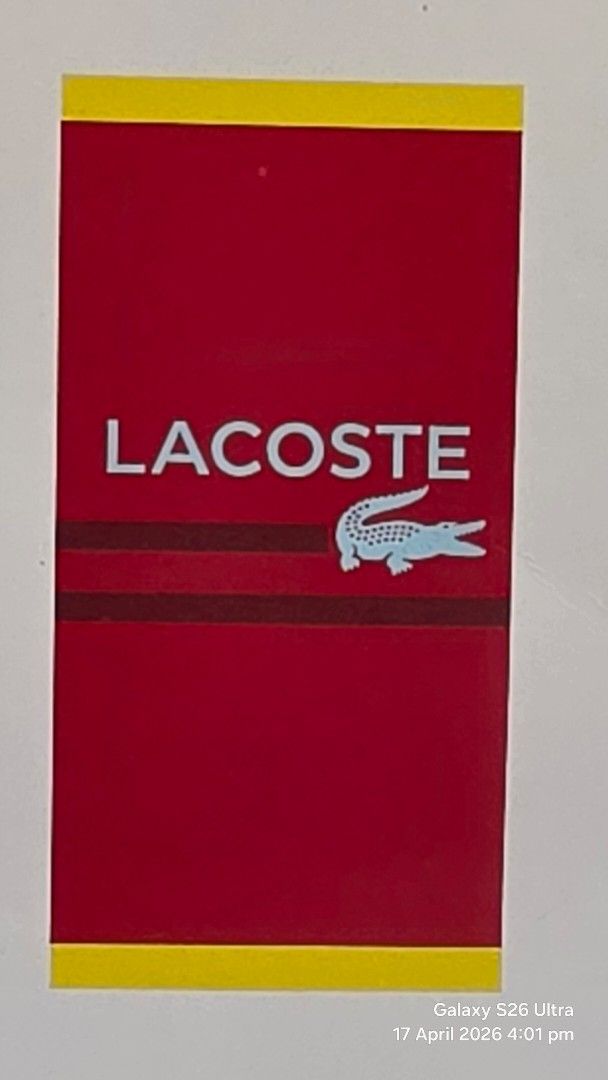 Original Lacoste Beach Towel 36" x 72" (Category: Bedding & Towels) located in Carmona. Submitted by Asimplehappinesstore (Listing ID 1432677757, Image 1). Description: - Brand new Lacoste beach towel - Made of 100% cotton - Features the Lacoste logo - Eye-catching red and yellow design - Generous size: 36" x 72" (91 x 183 cm) - Ideal for beach and pool use - Never been used.