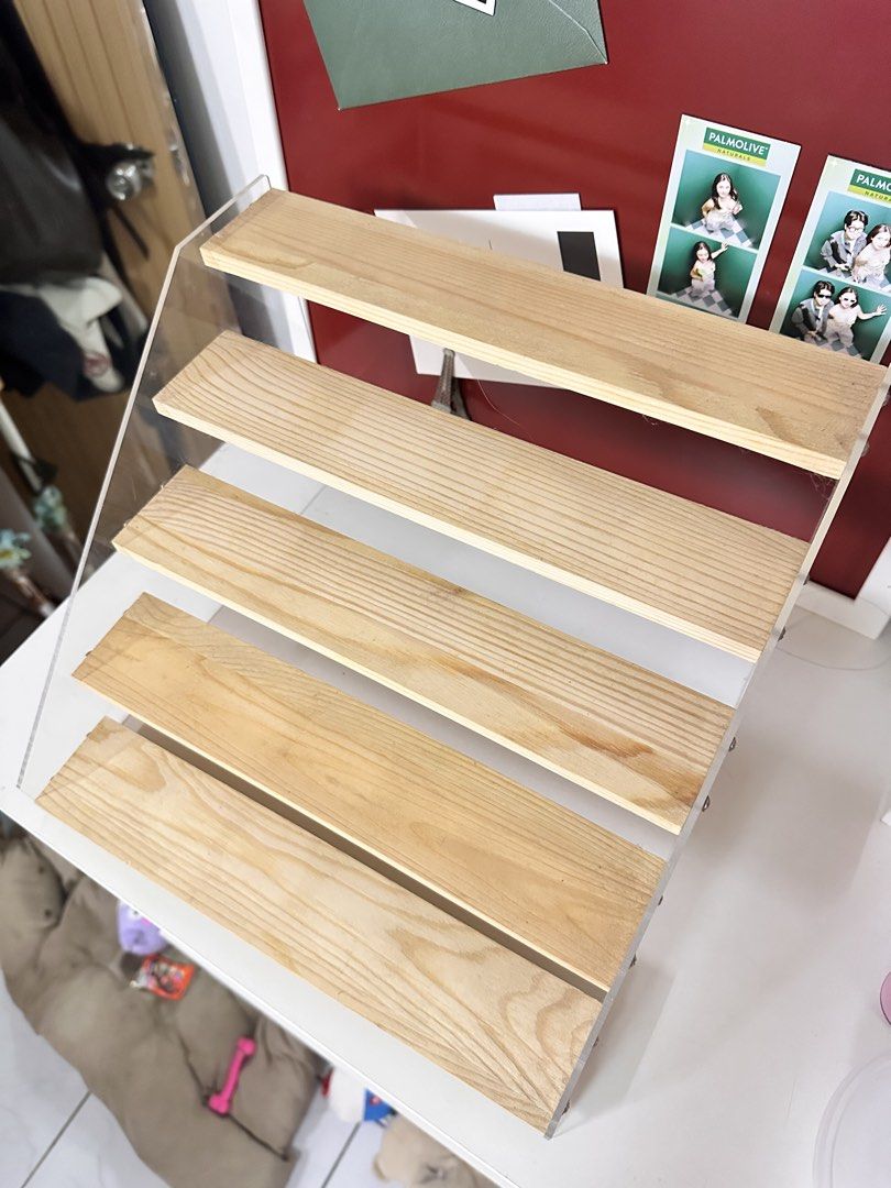 Perfume 5 tier Wooden Display Shelf (Category: Shelves, Cabinets & Racks) located in Quezon City. Submitted by shopsnazzy.mnl (Listing ID 1432626600, Image 3). Description: - Wooden display shelf - Clear acrylic sides - Four tiers - Light-colored wood shelves - Perfect for displaying collectibles, photos, or small items - Great for desks or shelves.