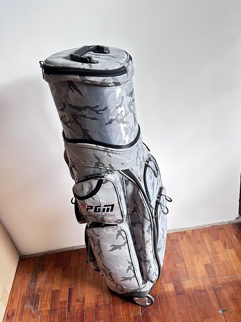 PGM Golf Bag in Camouflage with Wheels (Category: Golf) located in Mandaluyong City. Submitted by stealth_28 (Listing ID 1432714754, Image 3). Description: - PGM camouflage golf bag - Features multiple pockets for storage - Equipped with wheels for easy transport - Top handle for convenient carrying - Sturdy base and spacious interior - Comes with whole bag cover too Note: With usual wear & tear but only used few times. .