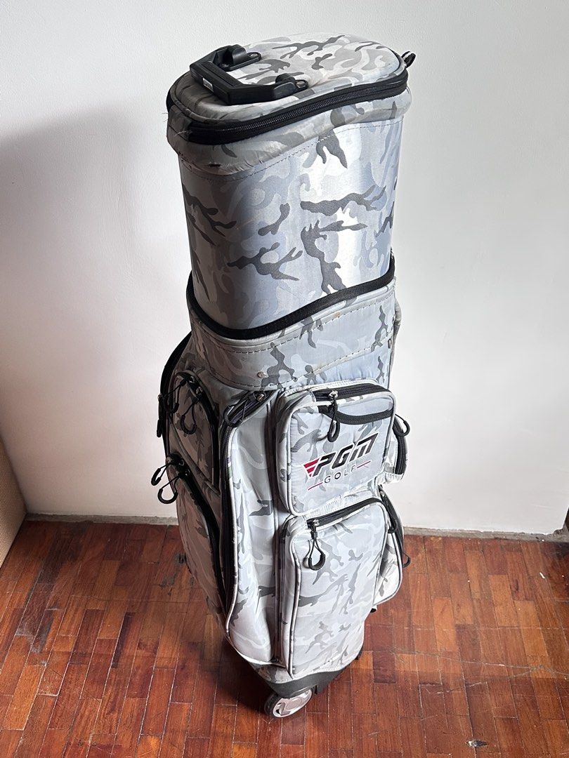 PGM Golf Bag in Camouflage with Wheels (Category: Golf) located in Mandaluyong City. Submitted by stealth_28 (Listing ID 1432714754, Image 1). Description: - PGM camouflage golf bag - Features multiple pockets for storage - Equipped with wheels for easy transport - Top handle for convenient carrying - Sturdy base and spacious interior - Comes with whole bag cover too Note: With usual wear & tear but only used few times. .