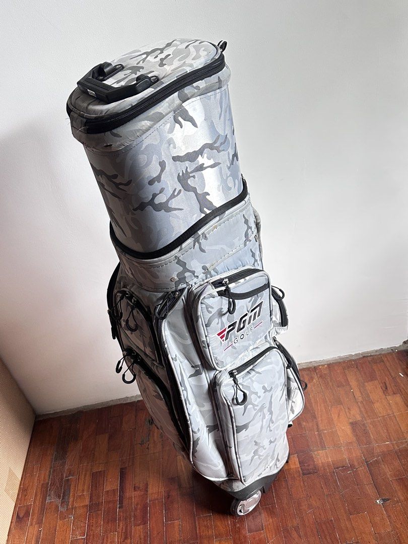 PGM Golf Bag in Camouflage with Wheels (Category: Golf) located in Mandaluyong City. Submitted by stealth_28 (Listing ID 1432714754, Image 2). Description: - PGM camouflage golf bag - Features multiple pockets for storage - Equipped with wheels for easy transport - Top handle for convenient carrying - Sturdy base and spacious interior - Comes with whole bag cover too Note: With usual wear & tear but only used few times. .