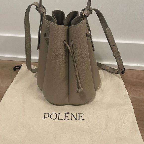 Polène Numero Sept Handbag (Category: Luxury Bags & Wallets) located in Makati City. Submitted by sustanableliving (Listing ID 1432615856, Image 1). Description: - Polène Numero Sept handbag - Neutral color - Drawstring closure - Shoulder strap - Unique, structured design - Includes dust bag - Made of textured material.