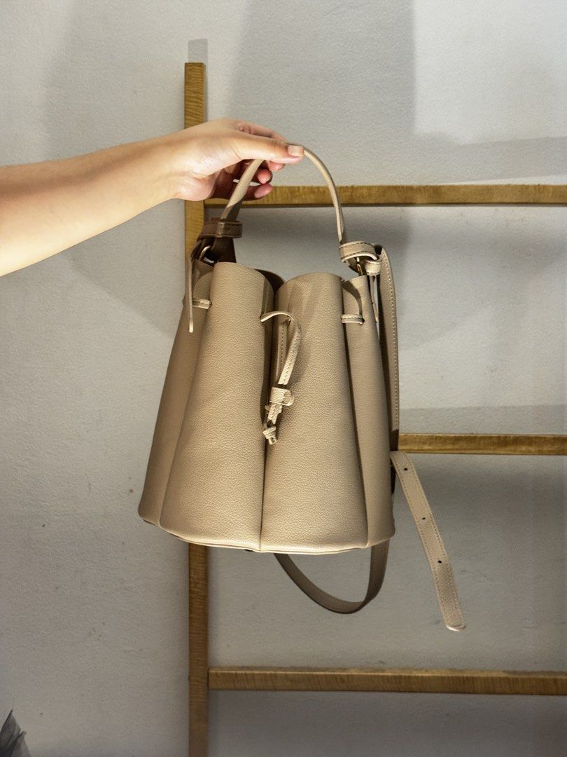 Polène Numero Sept Handbag (Category: Luxury Bags & Wallets) located in Makati City. Submitted by sustanableliving (Listing ID 1432615856, Image 3). Description: - Polène Numero Sept handbag - Neutral color - Drawstring closure - Shoulder strap - Unique, structured design - Includes dust bag - Made of textured material.