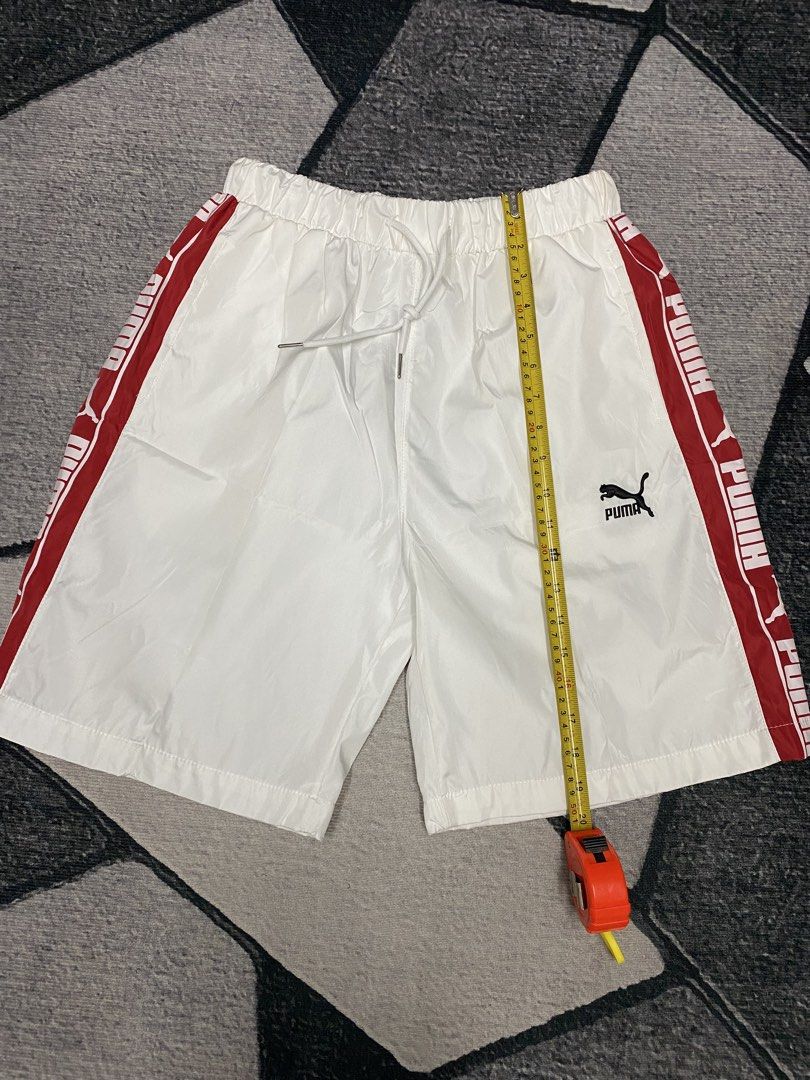 Puma White Shorts with Red Stripes (Category: Shorts) located in Las Pinas. Submitted by eFF01 (Listing ID 1432699398, Image 1). Description: - Puma shorts - Size: L - Color: White with red stripes - Features Puma logo - Elastic waistband with drawstring - Casual style, suitable for everyday wear or sports.