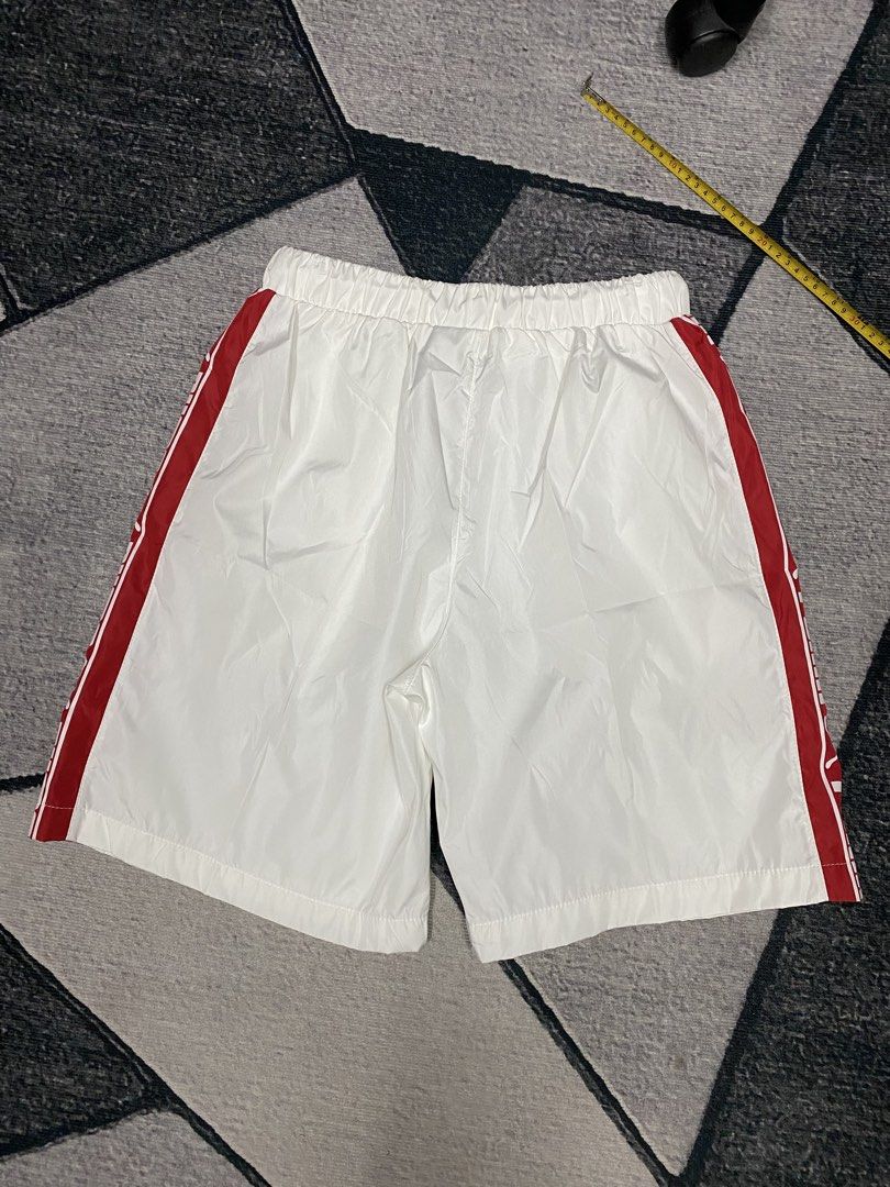 Puma White Shorts with Red Stripes (Category: Shorts) located in Las Pinas. Submitted by eFF01 (Listing ID 1432699398, Image 2). Description: - Puma shorts - Size: L - Color: White with red stripes - Features Puma logo - Elastic waistband with drawstring - Casual style, suitable for everyday wear or sports.
