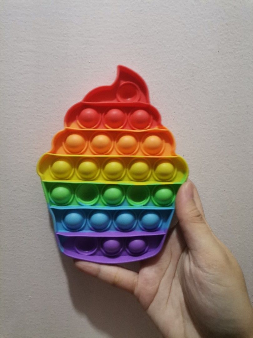 Rainbow Cupcake Pop It Fidget Toy (Category: Kids Toys) located in Makati City. Submitted by kookybearsstuff (Listing ID 1432713890, Image 1). Description: - Colorful cupcake Pop It fidget toy - Rainbow color scheme - Multiple bubbles for popping - Provides sensory stimulation and stress relief - Fun and engaging for all ages.