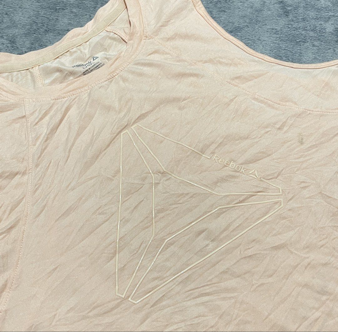 Reebok Tank Top (Category: Activewear) located in Sorsogon. Submitted by vanbercs (Listing ID 1432709123, Image 3). Description: - Reebok tank top - Light peach color - Reebok logo on front - Sleeveless - Size: Large to XLarge.