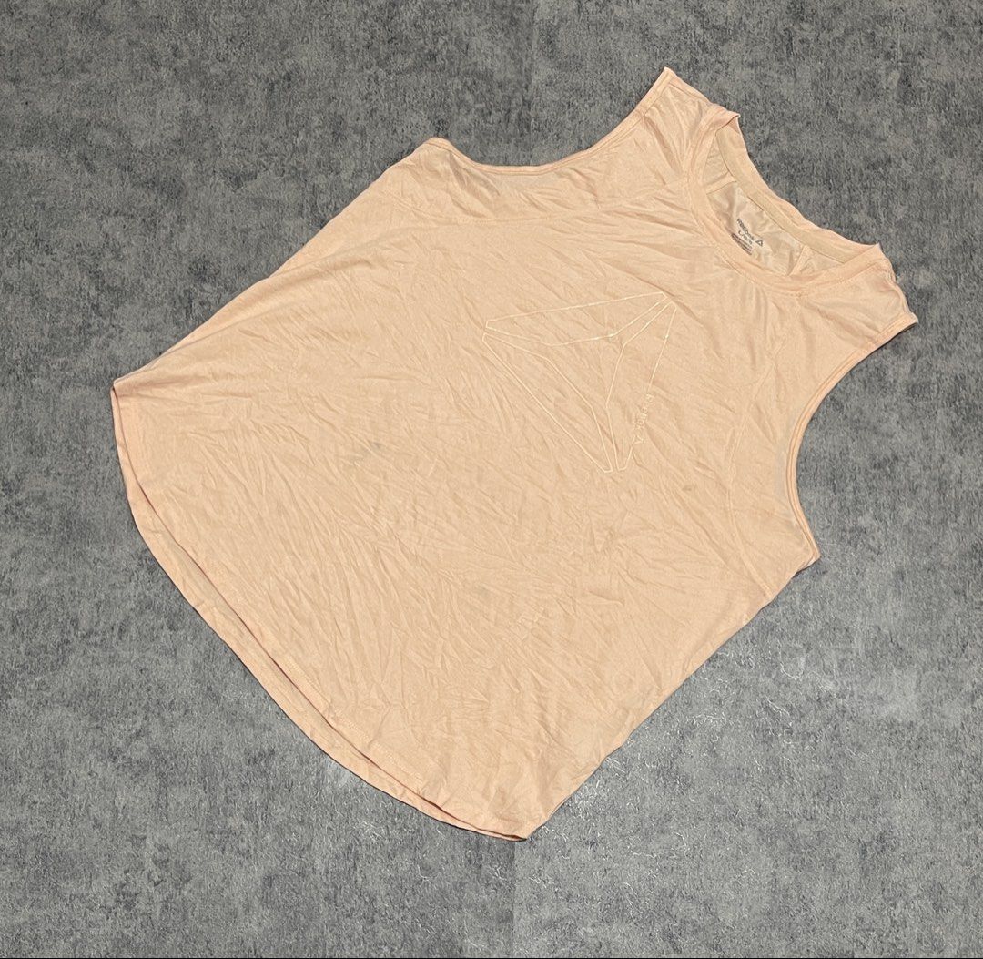 Reebok Tank Top (Category: Activewear) located in Sorsogon. Submitted by vanbercs (Listing ID 1432709123, Image 2). Description: - Reebok tank top - Light peach color - Reebok logo on front - Sleeveless - Size: Large to XLarge.