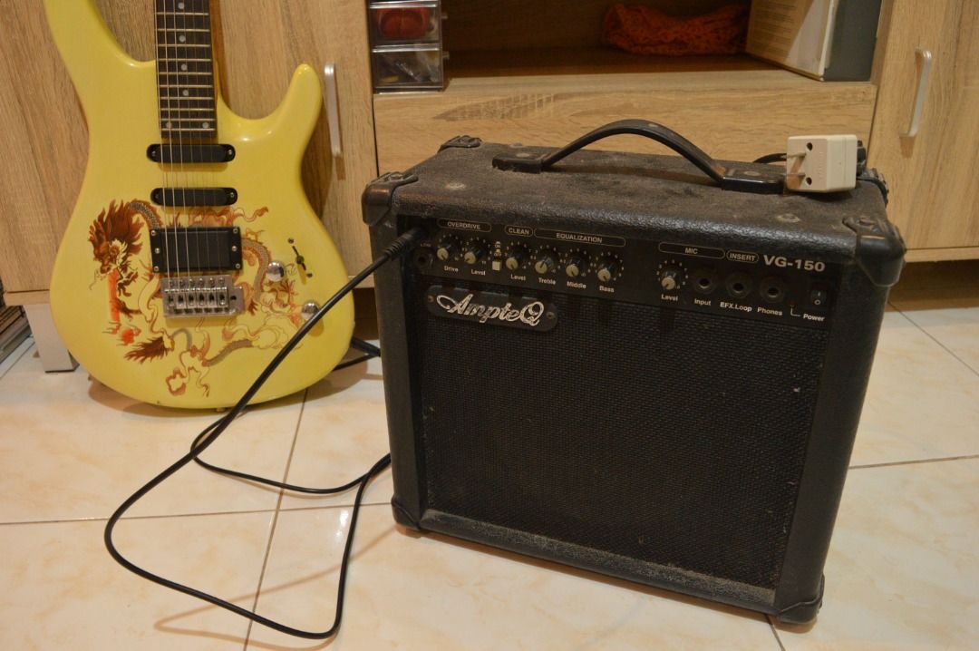 Rockstar Electric Guitar with AmpteQ Amplifier (Category: Musical Instruments) located in Bulacan. Submitted by kedl24 (Listing ID 1432702810, Image 2). Description: Electric guitar with a striking dragon design and a yellow body. Includes an AmpteQ VG-150 amplifier and a black cable. Dusty at medyo rusty ang amp but no issues new strings.