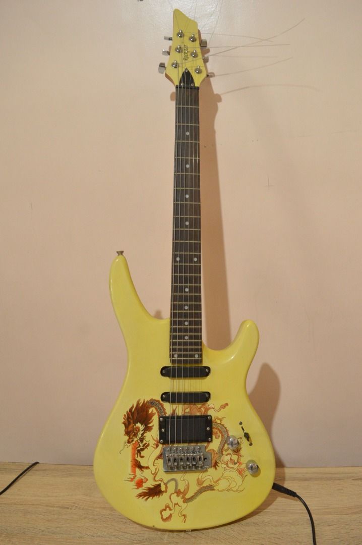 Rockstar Electric Guitar with AmpteQ Amplifier (Category: Musical Instruments) located in Bulacan. Submitted by kedl24 (Listing ID 1432702810, Image 1). Description: Electric guitar with a striking dragon design and a yellow body. Includes an AmpteQ VG-150 amplifier and a black cable. Dusty at medyo rusty ang amp but no issues new strings.