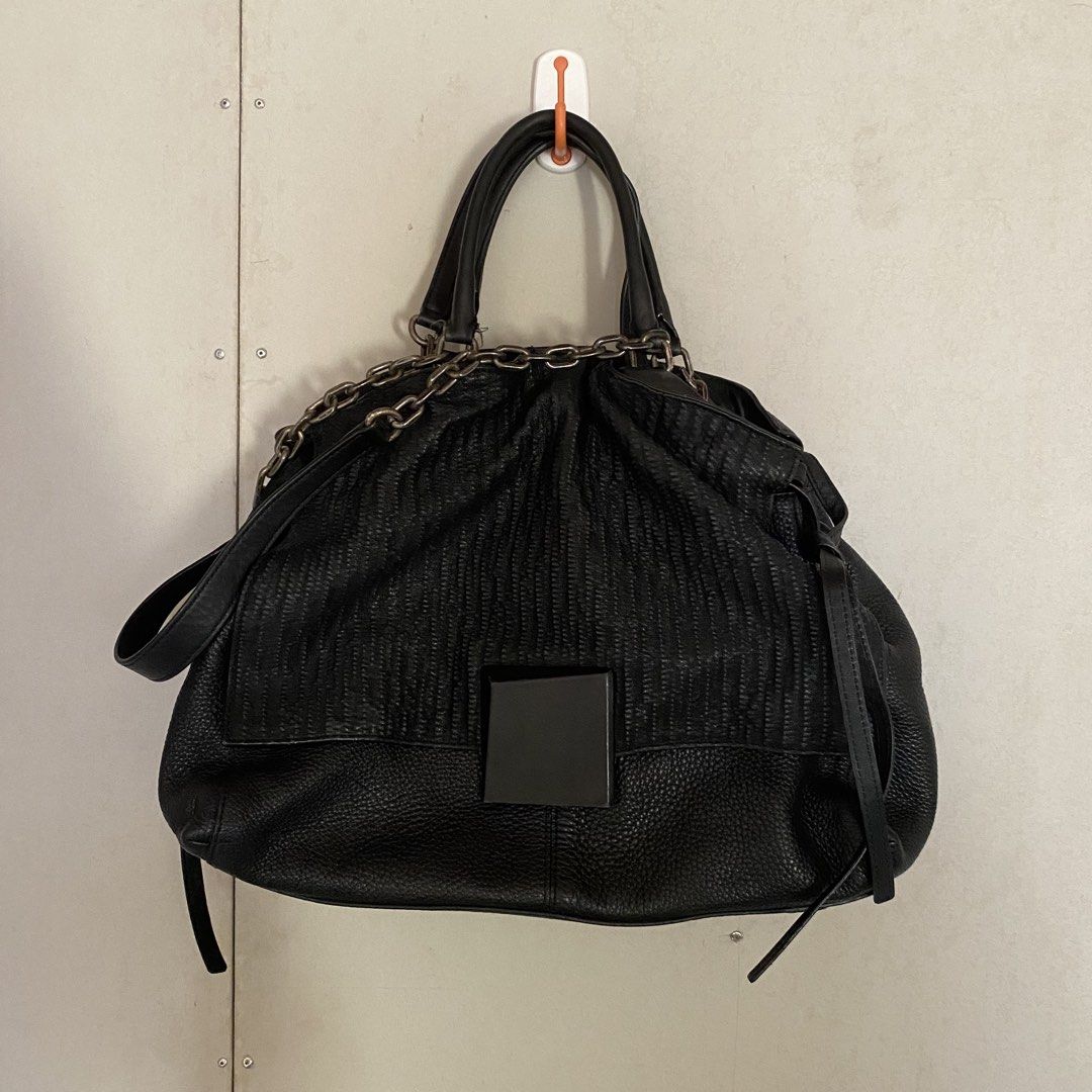 Rouge & Lounge Black Shoulder/Hand Bag (Category: Luxury Bags & Wallets) located in Iloilo. Submitted by elenmenope (Listing ID 1432789080, Image 1). Description: - Rouge & Lounge black handbag - Textured front panel - Chain detail - Top handle - Detachable shoulder strap - Interior: zippered pocket - Fabric lining - Square accent on front.