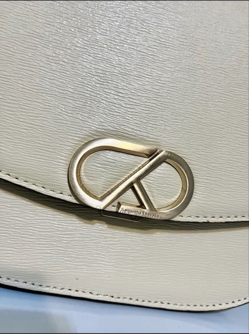 Samantha Thavasa Saddle Shoulder Bag (Category: Luxury Bags & Wallets) located in Quezon City. Submitted by whengaloolu (Listing ID 1432686511, Image 3). Description: - Samantha Thavasa shoulder bag in cream color - Flap closure with gold-toned logo - Detachable and adjustable shoulder strap - Structured shape - Smooth texture.