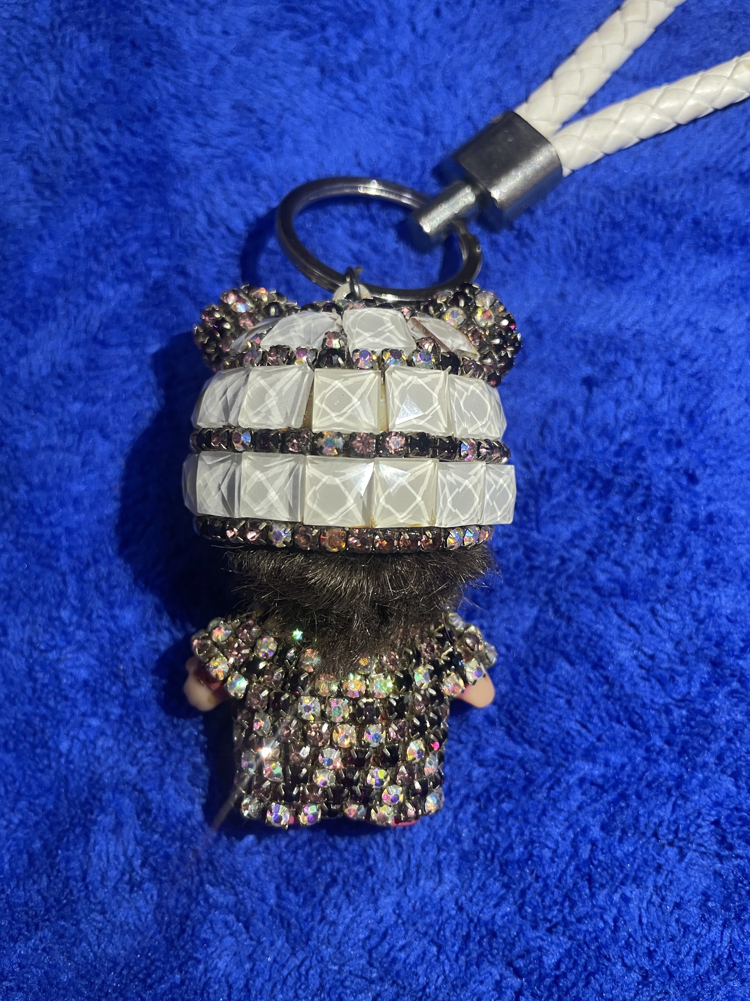 sparkling doll keychain (Category: Charms) located in Cebu City. Submitted by meeoowdeclutter (Listing ID 1432680691, Image 3). Description: - Adorable doll design - Sparkling rhinestone details - White braided strap - Silver keyring and tag - Cute and stylish accessory.