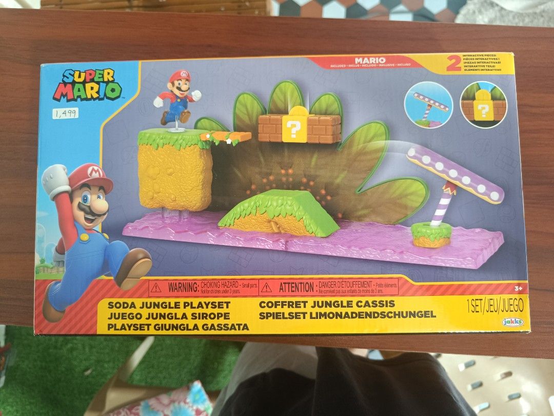 Super Mario Soda Jungle Playset (Category: Action & Battle Toys) located in Santa Ana. Submitted by smoothgotgame (Listing ID 1432749943, Image 1). Description: - Super Mario Soda Jungle Playset - Features a jungle-themed environment - Includes a Mario figure - Contains a question mark block - Features a platform - Includes a seesaw-like structure - 1 set/jeu/juego.