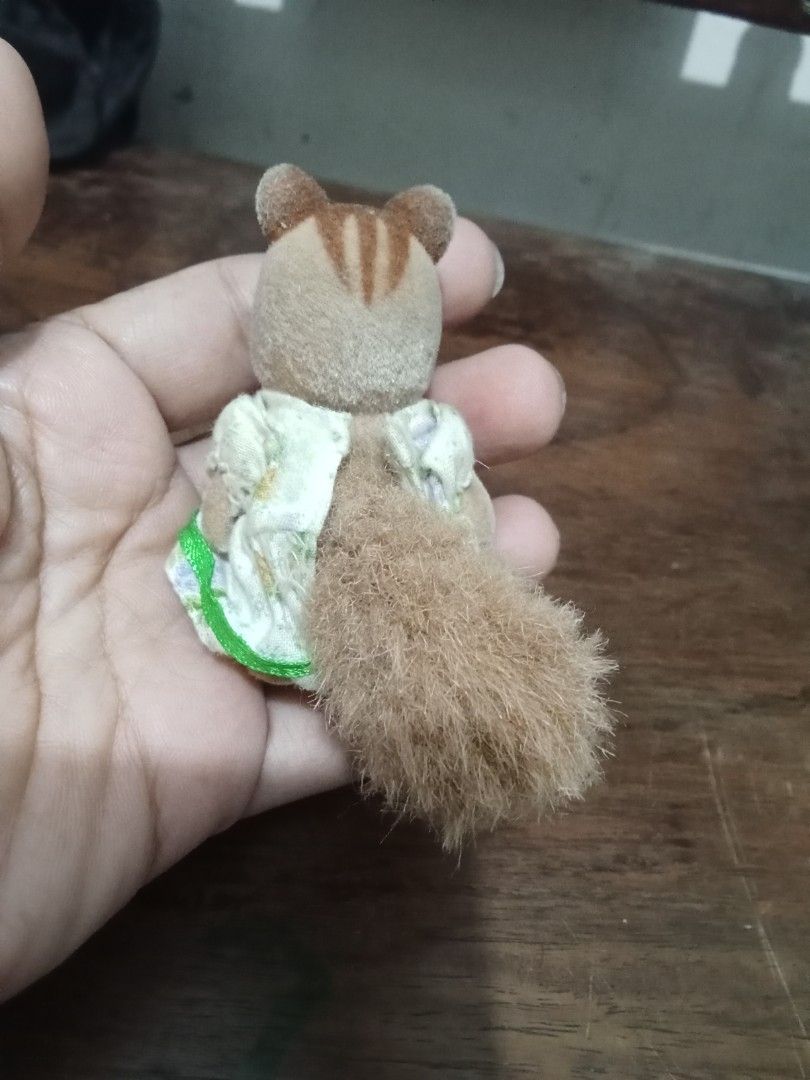 Sylvanian Families Chipmunk Figure (Category: Figurines & Statues) located in Bocaue. Submitted by marajapansurplus (Listing ID 1432639455, Image 3). Description: Adorable Sylvanian Families chipmunk figure is wearing a floral dress with a green trim and a brown bow. It has a fluffy tail and small feet..