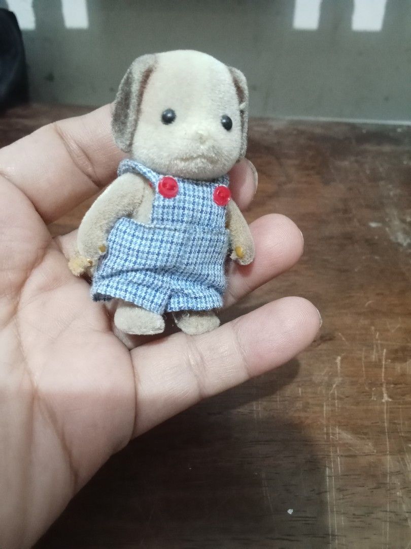 Sylvanian Families Dog Figure (Category: Figurines & Statues) located in Bocaue. Submitted by marajapansurplus (Listing ID 1432601510, Image 3). Description: - Adorable Sylvanian Families dog figure - Features blue overalls with red buttons - Light brown body with darker brown ears - Fluffy tail - Small and well-made - Perfect for collectors or play.