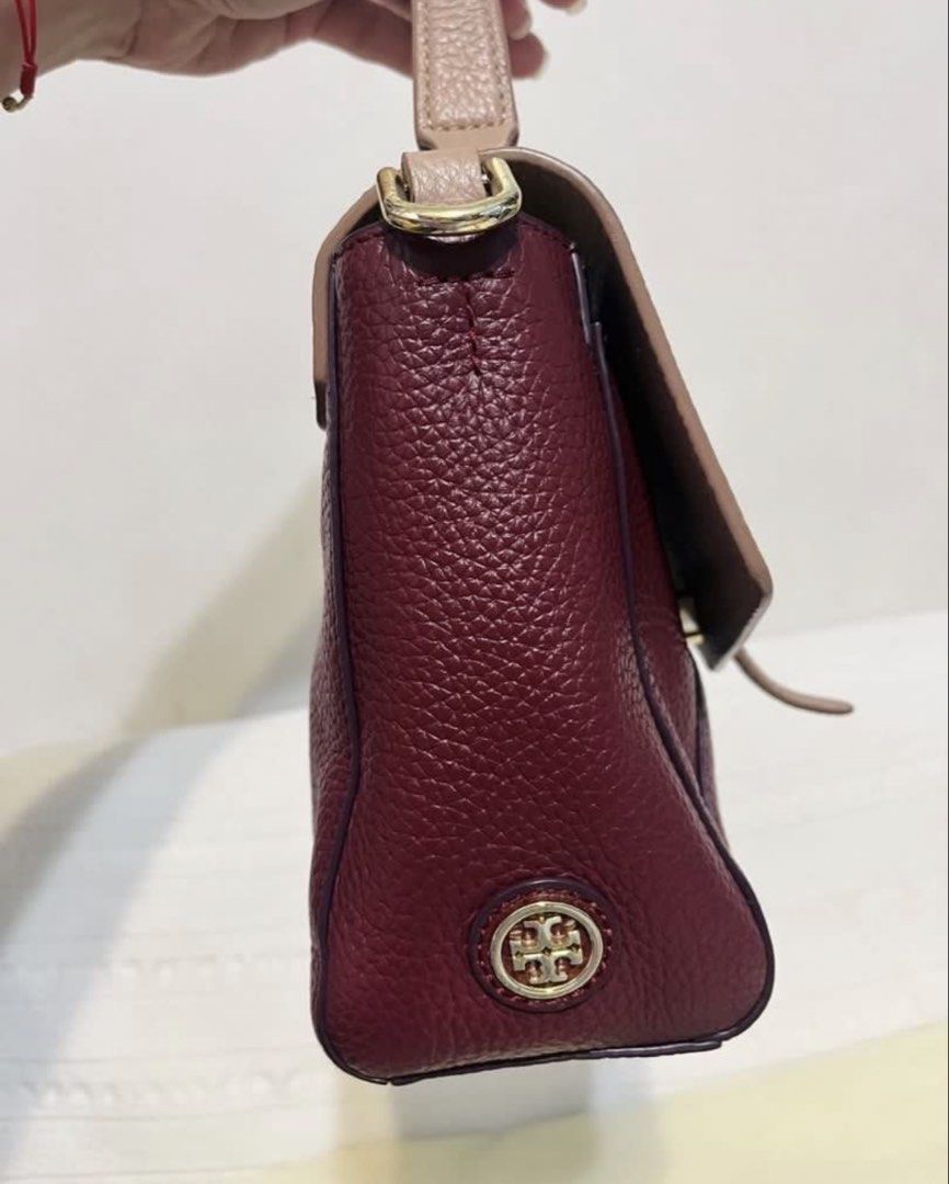 Tory Burch Small Satchel Bag (Category: Luxury Bags & Wallets) located in Quezon City. Submitted by whengaloolu (Listing ID 1432687105, Image 3). Description: - Tory Burch satchel bag - Two-tone design: burgundy body, neutral flap - Detachable shoulder strap - Top handle - Gold-toned logo - Interior zippered pocket - Leather construction.