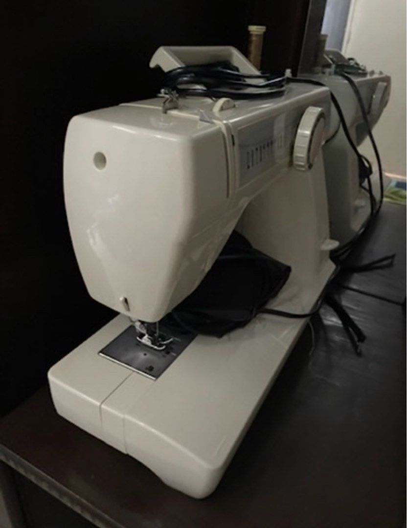 Toyota Sewing Machine (Category: Irons & Steamers) located in Bulacan. Submitted by ParisDeclutter (Listing ID 1432779296, Image 2). Description: - Toyota sewing machine - White color - Features: - Stitch selection dial - Carrying handle - Foot pedal - Power cord - Perfect for various sewing projects.