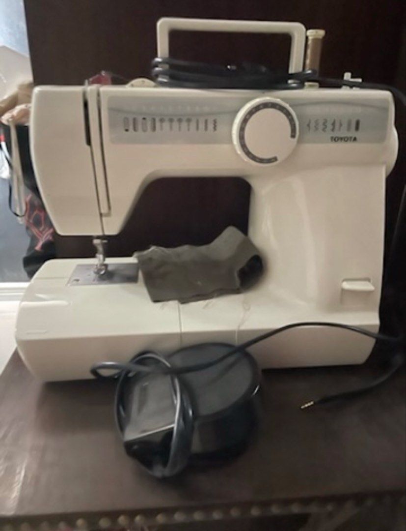 Toyota Sewing Machine (Category: Irons & Steamers) located in Bulacan. Submitted by ParisDeclutter (Listing ID 1432779296, Image 1). Description: - Toyota sewing machine - White color - Features: - Stitch selection dial - Carrying handle - Foot pedal - Power cord - Perfect for various sewing projects.