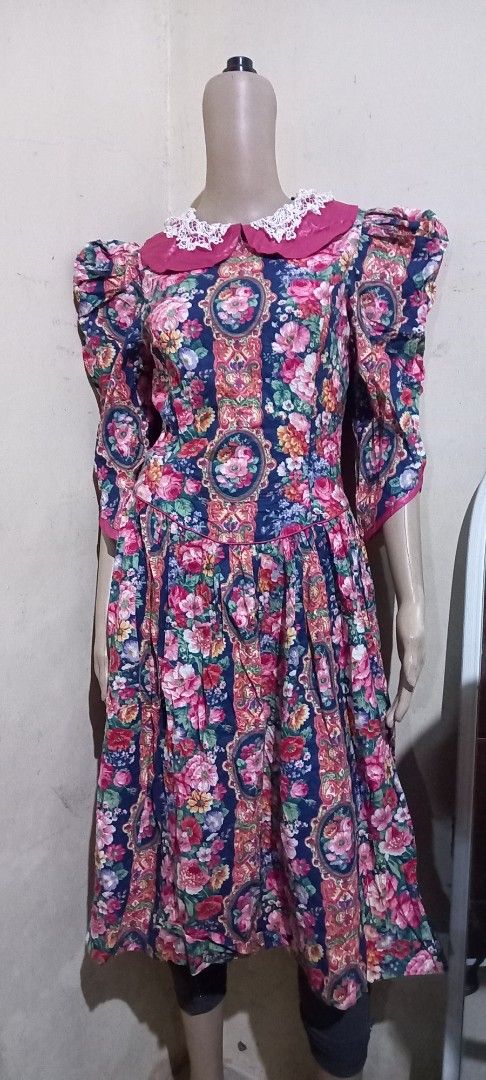 Vintage Floral Dress (Category: Dresses) located in San Pablo. Submitted by lheyab (Listing ID 1432610580, Image 1). Description: - Pictures Me dress - Size 7 - Floral pattern with dark blue background - Pink collar with white lace detailing - Long sleeves - Flowing design - Suitable for various occasions.