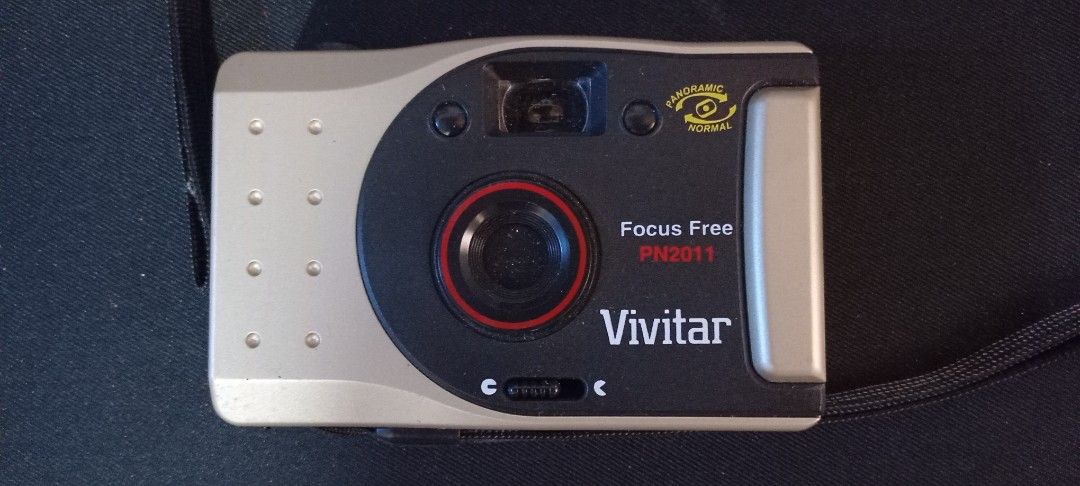 Vivitar Focus Free PN2011 Camera (Category: Cameras) located in Valenzuela. Submitted by consjavier74 (Listing ID 1432683670, Image 1). Description: - Vivitar Focus Free PN2011 camera - Focus-free design for easy use - Includes a wrist strap - Stylish black and silver color scheme - Distinctive lens with a red ring - Model number clearly visible - Features a top button and side dial 6 pcs available Dalandanan,Valenzuela City.