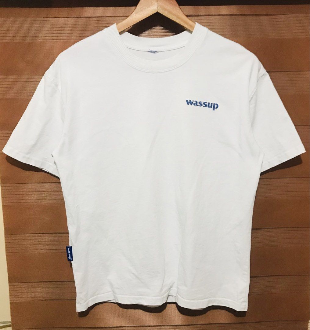Wassup White T-shirt (Category: Tshirts & Polo Shirts ) located in Rizal. Submitted by drthriftfour (Listing ID 1432616357, Image 1). Description: - White Wassup T-shirt - Made of 100% cotton - Features a small blue Wassup logo on the front - Made in China - Approximately 24 inches in length - Crew neck and short sleeves.
