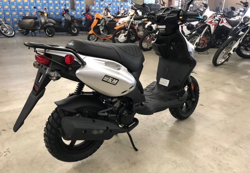 Yamaha Zuma 50 (Category: Motorbikes for Sale) located in Caloocan City. Submitted by wisewhale_7e3fc8 (Listing ID 1432600881, Image 3). Description: Yamaha Zuma 50 is a stylish scooter with a rugged design. It features a comfortable seat, a rear rack, and off-road tires. The scooter has a black and silver color scheme with red brake calipers..