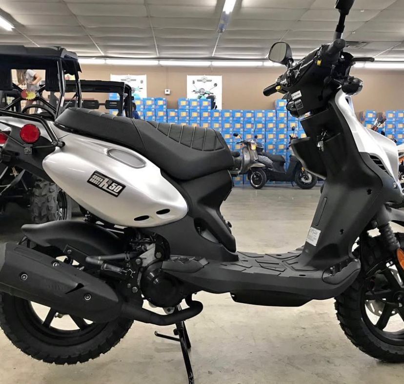 Yamaha Zuma 50 (Category: Motorbikes for Sale) located in Caloocan City. Submitted by wildgem_2f8f84 (Listing ID 1432601165, Image 3). Description: Yamaha Zuma 50 is a stylish scooter with a rugged design. It features a comfortable seat, a rear rack, and off-road tires. The scooter has a black and silver color scheme with red brake calipers..