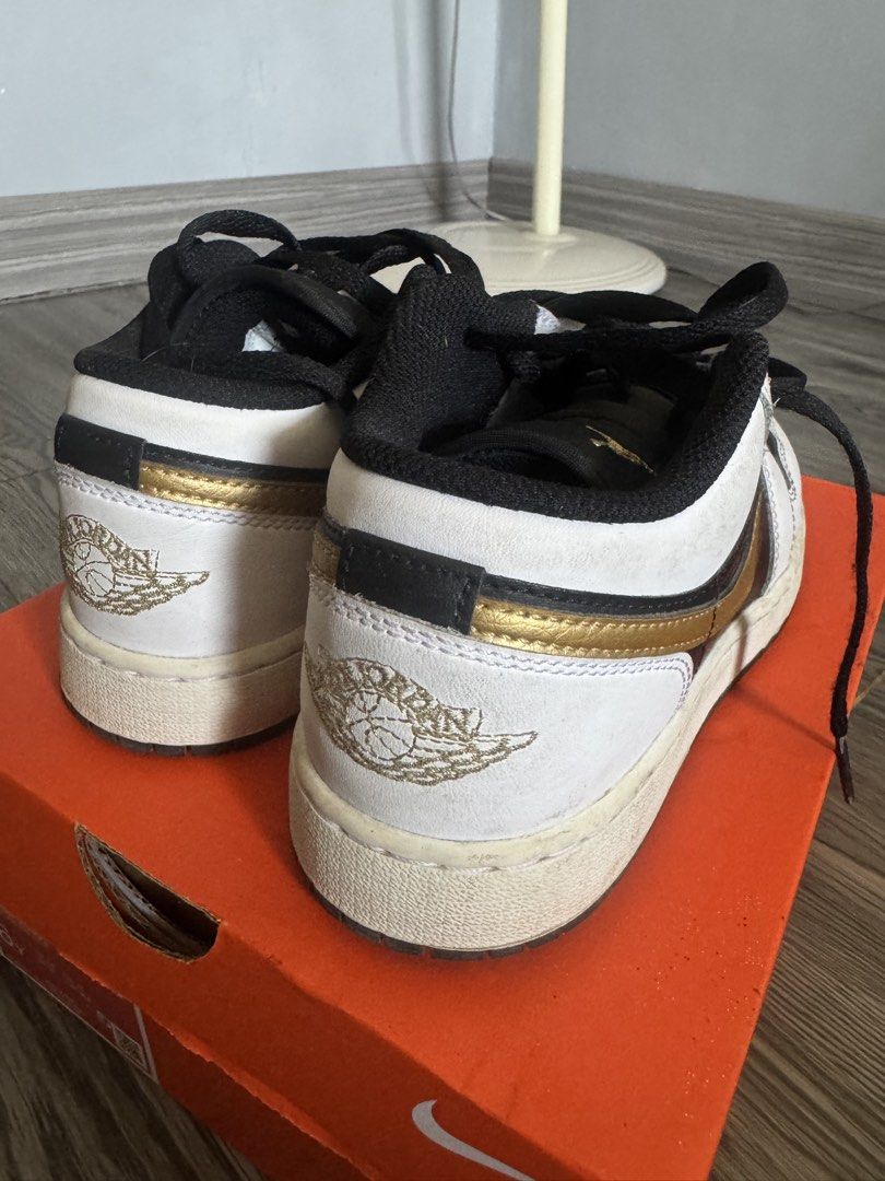 Air Jordan 1 Low Black Gold (Category: Babies & Kids Fashion) located in Las Pinas. Submitted by freeeezt (Listing ID 1432849391, Image 2). Description: - Air Jordan 1 Low sneakers - Colorway: Black, white, and gold - Features Air Jordan logo - Black laces and tongue - Size: US 4.5Y - Comes with original box.