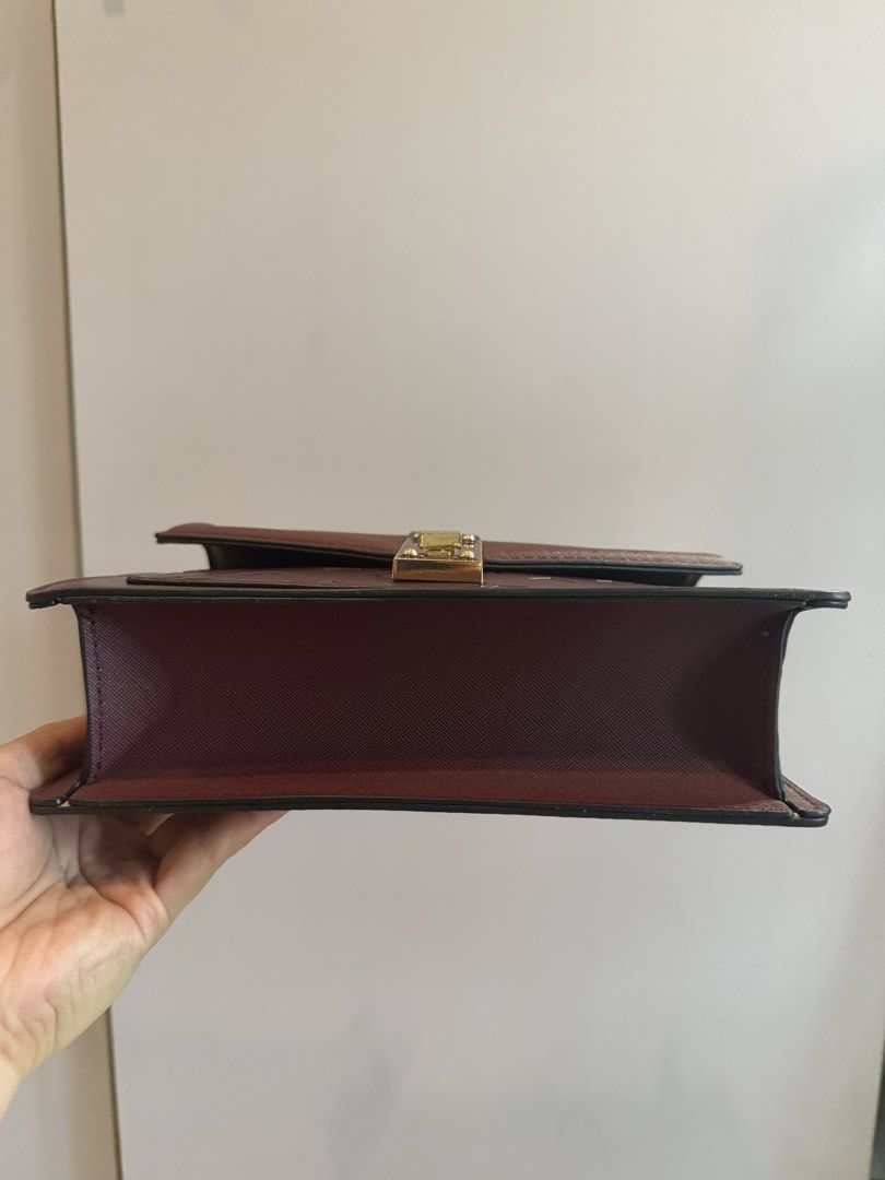 Aldo Burgundy Shoulder Bag with Chain Strap (Category: Shoulder Bags) located in Quezon City. Submitted by delkarl (Listing ID 1432876734, Image 3). Description: - Aldo burgundy shoulder bag - Gold-tone chain strap - Flap closure with gold-tone clasp - Embossed front pattern (hearts, stars, diamonds) - Patterned lining - Interior zippered pocket - Aldo logo on the back.