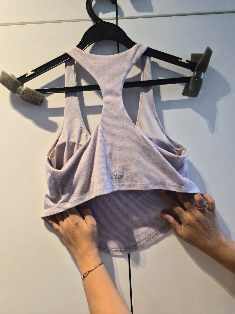 Alo Yoga Cropped Tank Top (Category: Activewear) located in Singapore. Submitted by greatdealwithdb (Listing ID 1432863075, Image 2). Description: - Alo Yoga tank top (padded) - Ribbed texture - Racerback design - Suitable for yoga, workouts, and casual wear.