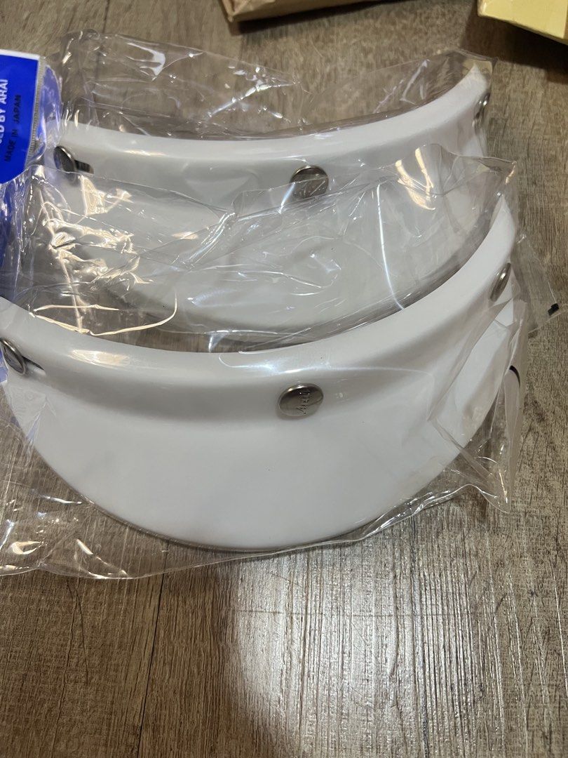 Arai, Bell & Extra Shield - Peak Cap Visor (3 Button) (Category: Motorcycle Accessories) located in Singapore. Submitted by frozenconstellations (Listing ID 1432854384, Image 1). Description: New in original packaging. For Arai Classic SW, Classic Air, Classic Mod Helmets etc For Bell (Left 1) May fit other helmets utilising 3 buttons type too Black (Arai and Bell) White (Arai) Silver (Arai) [Used] Yamashiro Extra Shield Bubble Visor (3 button) .
