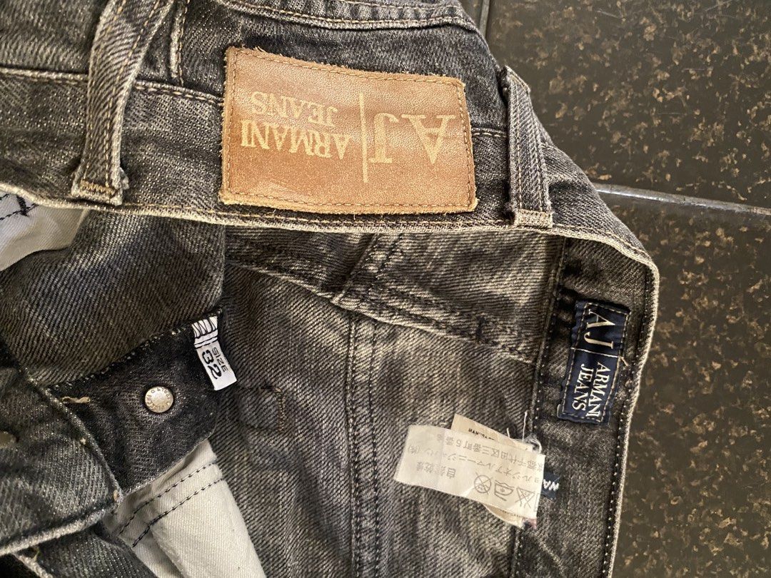 Armani Jeans - Grey Denim Jeans (Category: Jeans) located in Calapan. Submitted by yowstuff (Listing ID 1432993747, Image 3). Description: - Armani Jeans denim pants in grey - Classic five-pocket design - Button closure - Straight leg cut - Armani Jeans leather logo patch at the back - Size tag visible.