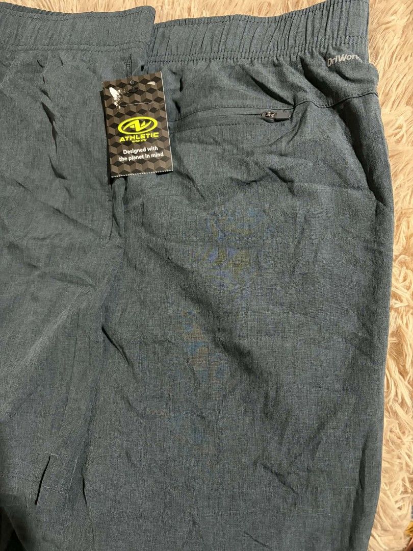 Athletic Works Men's Shorts (Category: Shorts) located in Pateros City. Submitted by armcandystuff (Listing ID 1432868250, Image 2). Description: - Athletic Works men's shorts - 48-50 inches waist - Solid teal color - Drawstring waistband - Back pocket with zipper - Dry-wick technology.