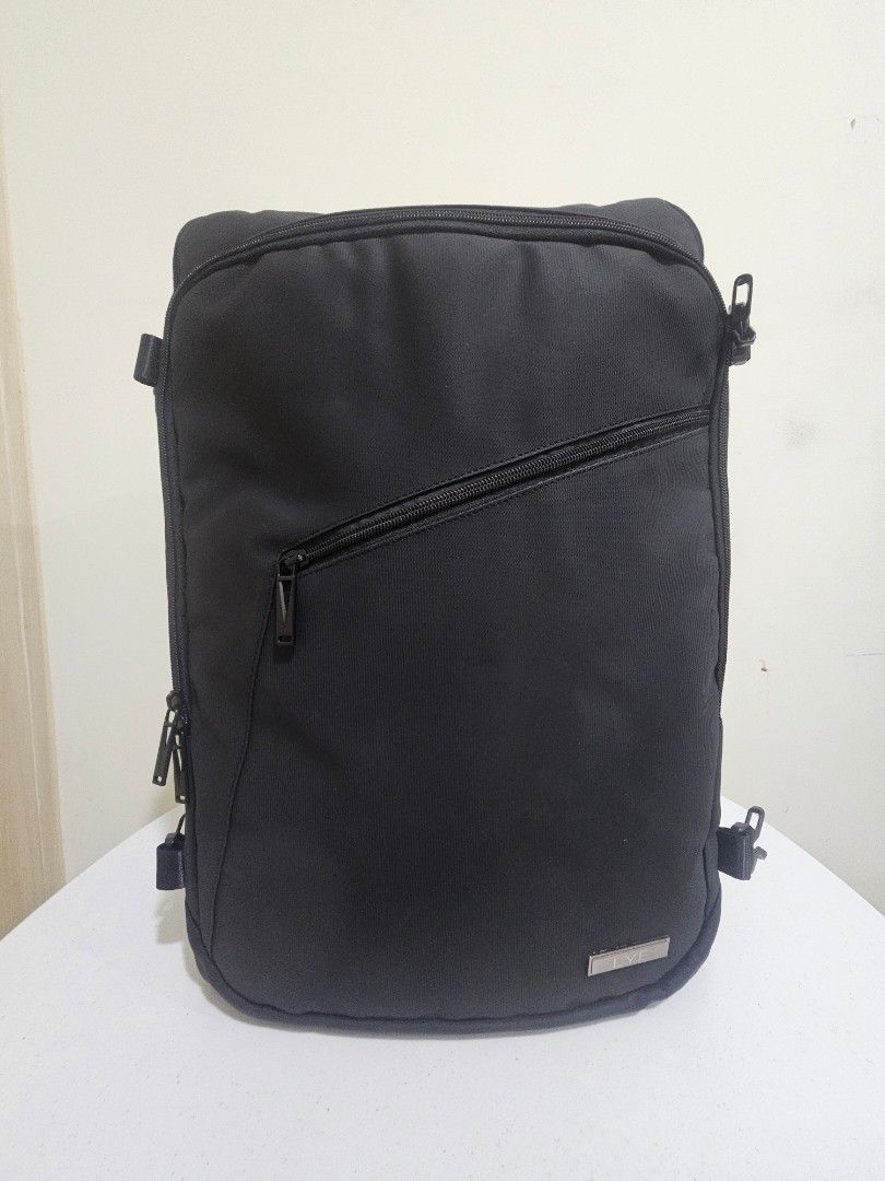 Black Travel Backpack with Organizer, Vacuum Bag + Pump (Category: Backpacks) located in Marilao. Submitted by ____jnsk (Listing ID 1432972198, Image 2). Description: - Black travel backpack - Multiple compartments for organized packing - Zippered pockets and mesh dividers - Interior straps to secure belongings - Padded compartment - Handle and shoulder strap - Copenhagen design.
