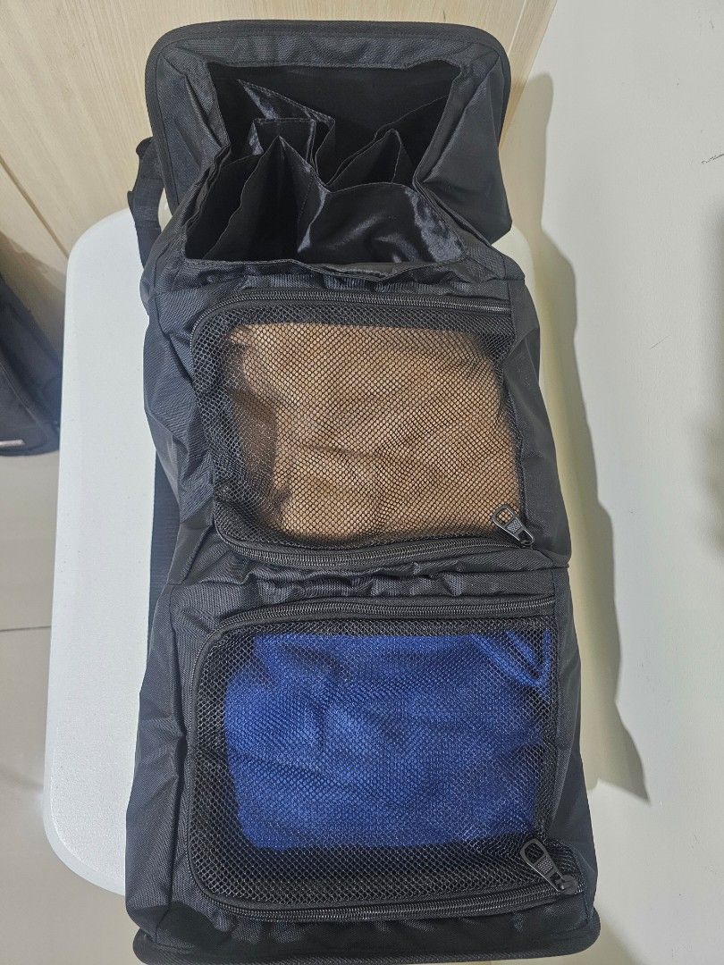 Black Travel Backpack with Organizer, Vacuum Bag + Pump (Category: Backpacks) located in Marilao. Submitted by ____jnsk (Listing ID 1432972198, Image 3). Description: - Black travel backpack - Multiple compartments for organized packing - Zippered pockets and mesh dividers - Interior straps to secure belongings - Padded compartment - Handle and shoulder strap - Copenhagen design.