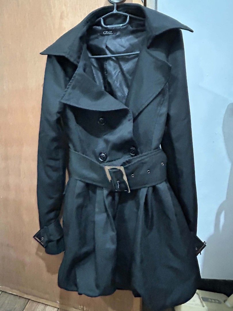 Black Trench Coat with Belt (Category: Coats, Jackets and Outerwear) located in Makati City. Submitted by gwentra (Listing ID 1432971224, Image 2). Description: - Black trench coat - Double-breasted design - Stylish belt with silver buckle - Balloon bottom - Classic collar - Adds sophistication to any outfit.