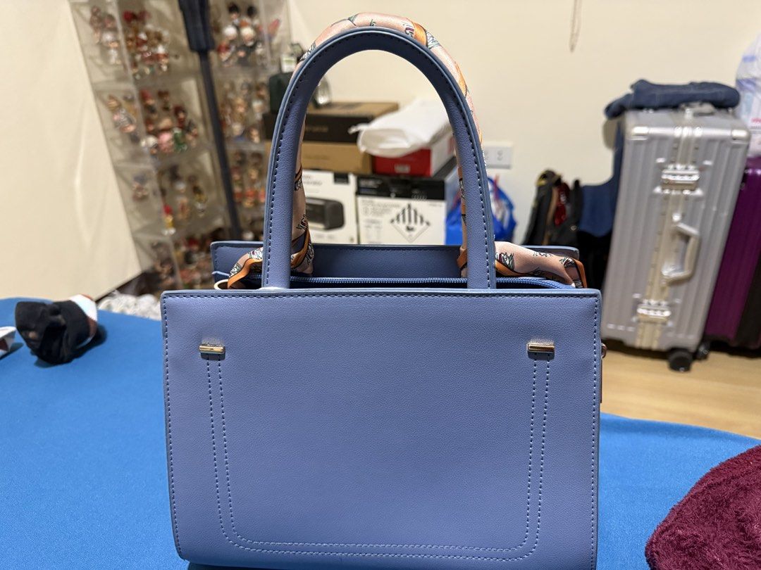 Blue Handbag with Scarf Handle (Category: Shoulder Bags) located in Manila. Submitted by flicker_33 (Listing ID 1432846692, Image 2). Description: - Stylish blue handbag - Decorative scarf on handles - Structured design - Top zipper closure - Gold-colored feet - Includes matching blue shoulder strap - Perfect for everyday or special events.