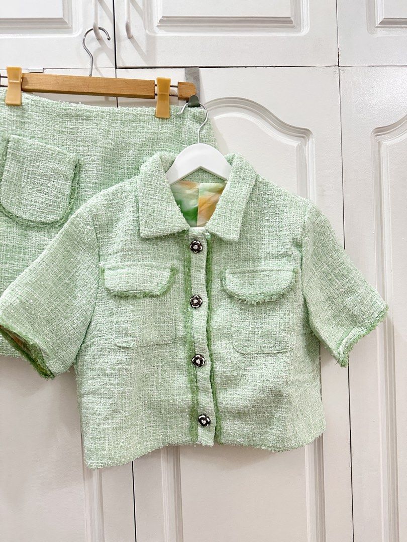 Ch@nel Tweed Skirt Suit (Category: Skirts) located in Manila. Submitted by kspassion (Listing ID 1432802816, Image 2). Description: - Chanel tweed skirt suit - Soft green color - Short-sleeved jacket with decorative buttons - Jacket features two front pockets - Classic collar on jacket - Matching skirt included - Jacket lining with colorful floral pattern - Perfect for a chic and sophisticated look Free size fits medium to semi Xl Waist 26-28.