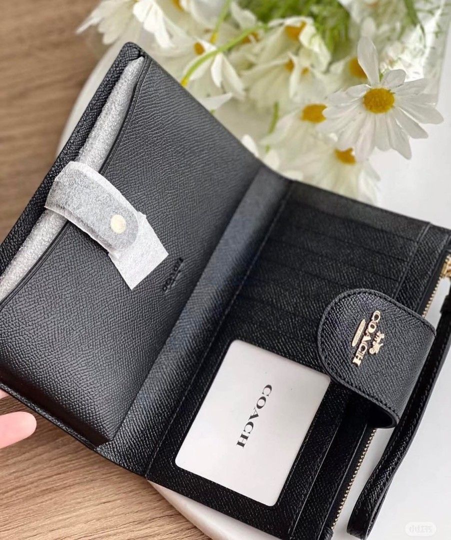 Coach Tech Wallet (Category: Other Accessories) located in Rizal. Submitted by vanbdc24 (Listing ID 1432856574, Image 2). Description: - Authentic Coach wristlet wallet - Color: Black - Features a snap closure with Coach logo - Includes a wrist strap - Zippered compartment for secure storage - Interior with card slots - Comes with a Coach card - Material: Leather.
