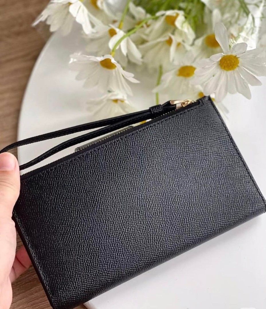 Coach Tech Wallet (Category: Other Accessories) located in Rizal. Submitted by vanbdc24 (Listing ID 1432856574, Image 3). Description: - Authentic Coach wristlet wallet - Color: Black - Features a snap closure with Coach logo - Includes a wrist strap - Zippered compartment for secure storage - Interior with card slots - Comes with a Coach card - Material: Leather.
