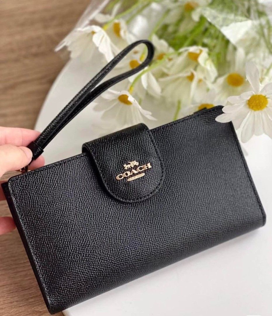 Coach Tech Wallet (Category: Other Accessories) located in Rizal. Submitted by vanbdc24 (Listing ID 1432856574, Image 1). Description: - Authentic Coach wristlet wallet - Color: Black - Features a snap closure with Coach logo - Includes a wrist strap - Zippered compartment for secure storage - Interior with card slots - Comes with a Coach card - Material: Leather.