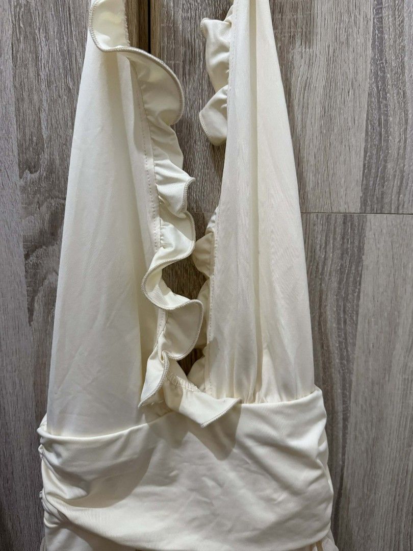 Cream Halter Dress with Ruffles (Category: Dresses) located in Cavite. Submitted by ahlecz13 (Listing ID 1432950468, Image 3). Description: - Cream-colored halter dress/cover up - Ruffled design - Gathered waist detail - Asymmetrical hemline - Versatile for casual or beach outings Only used once. Bought it for Php500+.