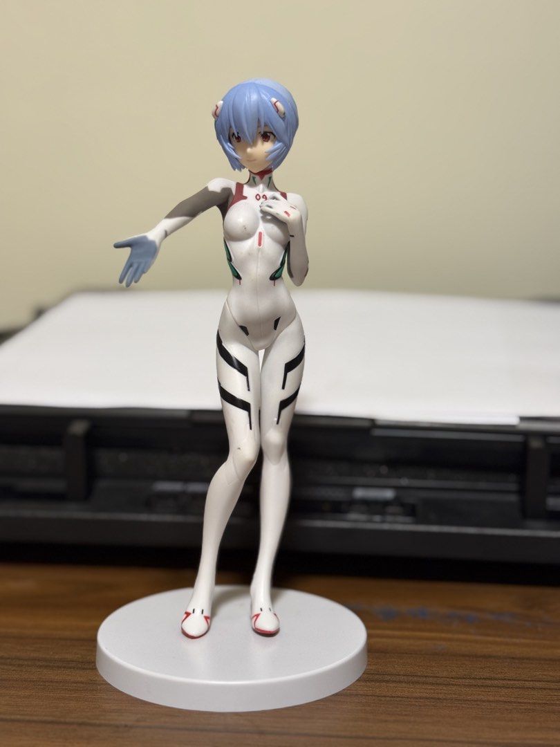Evangelion - Rei Ayanami (Standard Plugsuit) Figure (Category: Figurines & Statues) located in Baguio. Submitted by swift_treasure.mart (Listing ID 1432935153, Image 1). Description: Evangelion - Rei Ayanami (Standard Plugsuit) Figure Item Details: • Brand/Character: SEGA / Evangelion (Rei Ayanami) • Specs: Standard white plugsuit variant with a round white base. Official SEGA marked prize figure. • Condition: Surplus/Loose. Pre-loved but in exce