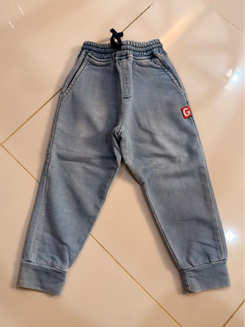 Garfield 3T Denim Jogger Pants (Category: Babies & Kids Fashion) located in Urdaneta. Submitted by glamduck (Listing ID 1432872385, Image 1). Description: - Brand: Garfield - Size: 3T - Style: Denim jogger pants - Features: Elastic waistband with drawstring - Pockets: Two front pockets, one back pocket - Detail: Small red "G" patch on front.