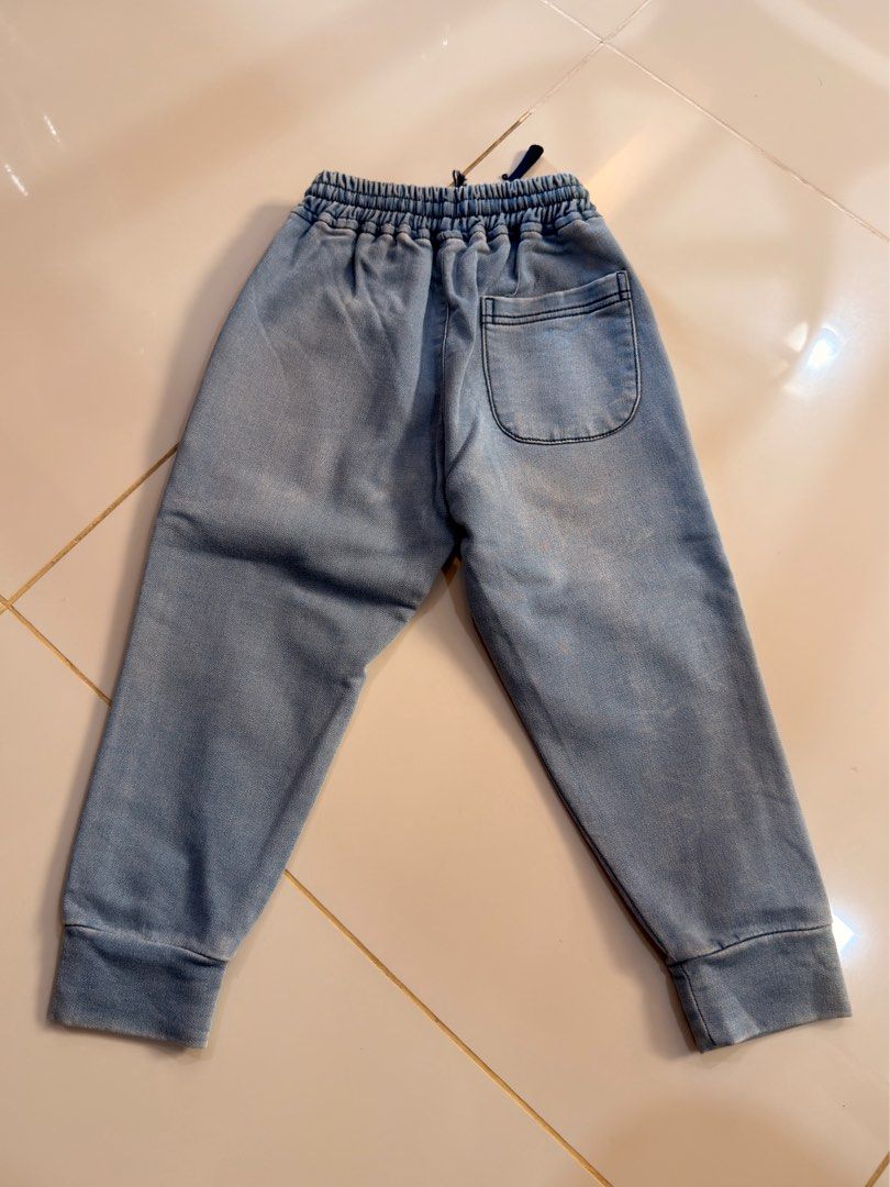 Garfield 3T Denim Jogger Pants (Category: Babies & Kids Fashion) located in Urdaneta. Submitted by glamduck (Listing ID 1432872385, Image 2). Description: - Brand: Garfield - Size: 3T - Style: Denim jogger pants - Features: Elastic waistband with drawstring - Pockets: Two front pockets, one back pocket - Detail: Small red "G" patch on front.