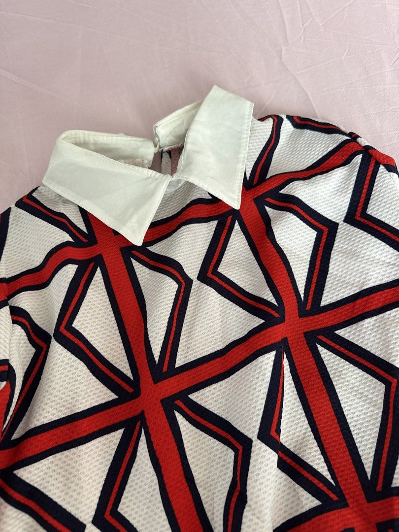 Geometric Print Long Sleeve Top (Category: Longsleeves) located in Manila. Submitted by aimelamode (Listing ID 1432864182, Image 2). Description: - Long-sleeved top with a geometric red and black pattern on a white background. - Features a collared neckline and fitted cuffs. - Made with textured fabric. - Designed with a fitted silhouette. - Perfect for various occasions..