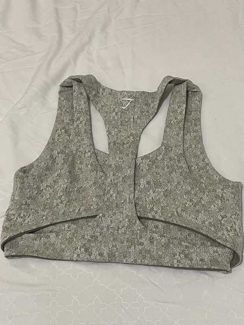 Gymshark Sports Bra (Category: Activewear) located in Las Pinas. Submitted by serialthrifter (Listing ID 1432957557, Image 2). Description: - Gymshark sports bra - Unique patterned design - Color: Olive green and white - Racerback style - Scoop neckline - Gymshark logo on the back - Made of stretchy, athletic material.