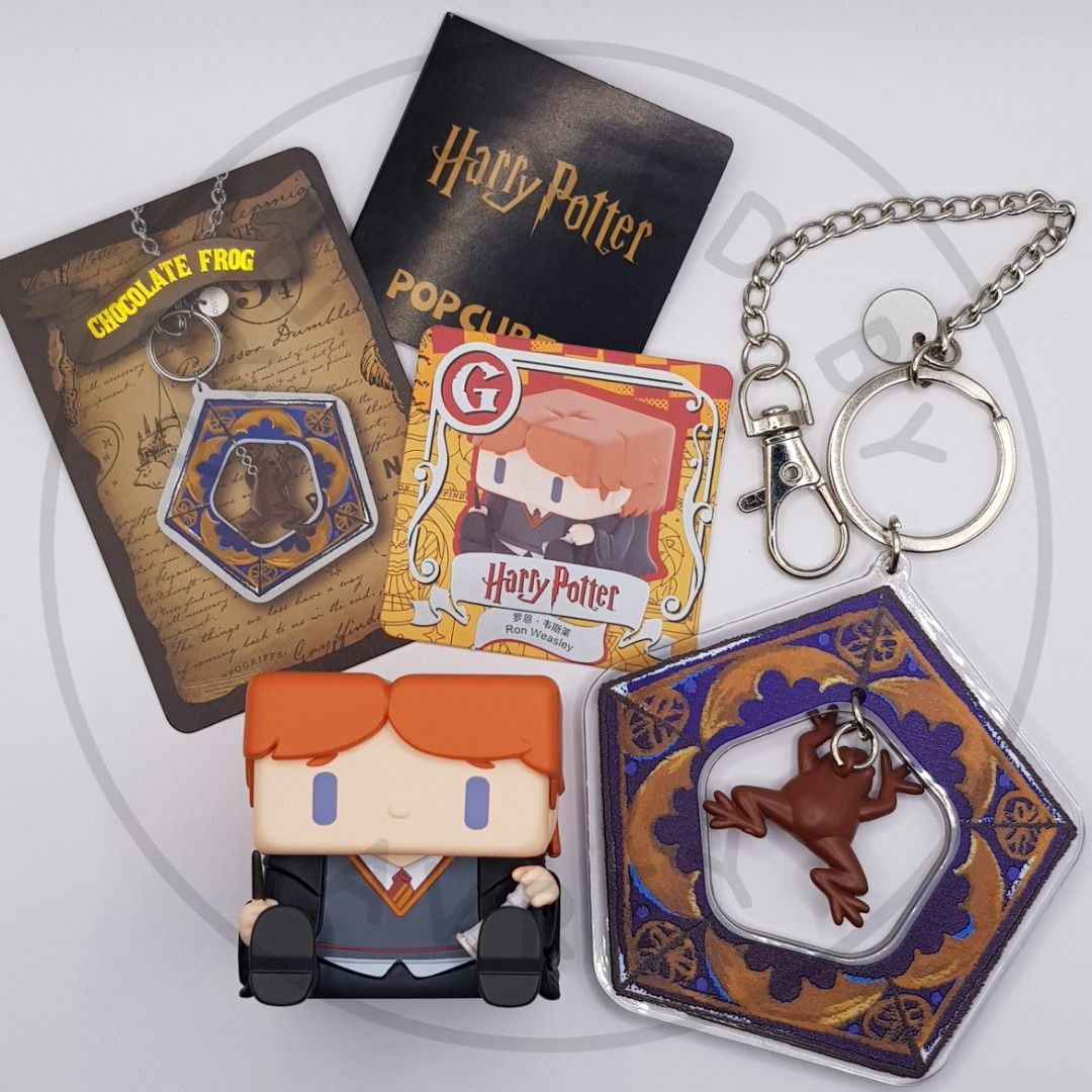 Harry Potter POP CUBE + Harry Potter Chocolate Frog Keychain SET (Category: Western Merchandise) located in Lipa City. Submitted by prelovedbyavrey (Listing ID 1432962347, Image 1). Description: SOLD AS SET ONLY - Harry Potter Chocolate Frog Keychain - Ron Weasley Figure (Hogwarts Uniform) - Ron Weasley Card.