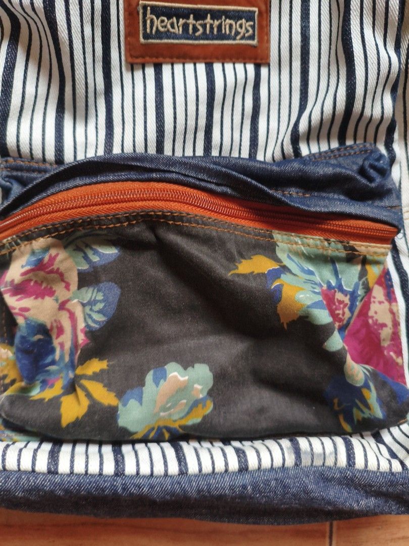 BRAND NEW! Heartstrings Striped Backpack (Category: Backpacks) located in Pasig City. Submitted by coolphoenix-29ac (Listing ID 1432896333, Image 3). Description: - Heartstrings backpack with a unique striped pattern. - Features a denim front pocket and charming floral accents. - Adjustable shoulder straps and a convenient top handle. - Includes a zippered front pocket for easy access. - Spacious main compartment with a neutral fabric lining. - D